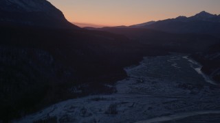 AK0001_1106 - 4K aerial stock footage flying over the snow covered Matanuska River Valley at sunset, Alaska