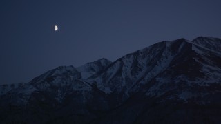 AK0001_1117 - 4K stock footage aerial video the moon over the snow covered Chugach Mountains at night, Alaska
