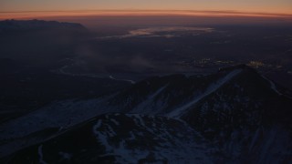 AK0001_1137 - 4K aerial stock footage snow covered Chugach Mountains toward Knik River Valley, Alaska, twilight