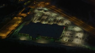 AK0001_1144 - 4K aerial stock footage shopping center by Glenn Highway/Highway 1, Eagle River, Alaska, night