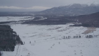 AK0001_1158 - 4K aerial stock footage Glenn Highway to snowy Chugach Mountains, Fort Richardson, Anchorage, Alaska