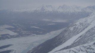 AK0001_1210 - 4K stock footage aerial video Butte and Knik River Valley at base of snow covered Chugach Mountains, Alaska