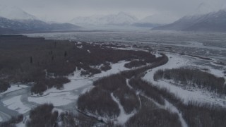 AK0001_1227 - 4K aerial stock footage flying over snow covered brush and rivers, Knik River Valley, Alaska