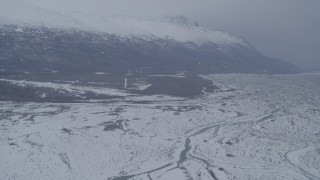 AK0001_1231 - 4K aerial stock footage flying toward base of snowy Chugach Mountains in Knik River Valley, Alaska