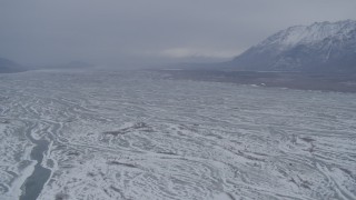 AK0001_1232 - 4K aerial stock footage approaching snowy Knik River Valley, Alaska