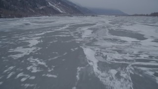 AK0001_1276 - 4K stock footage aerial video flying over frozen ground and iced over rivers, Butte, Alaska