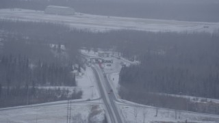 AK0001_1319 - 4K aerial stock footage a checkpoint on D Street near Bryant Army Heliport in snow, Anchorage, Alaska