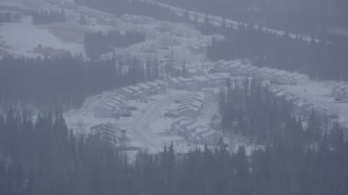 AK0001_1321 - 4K aerial stock footage a neighborhood and trees in falling snow, Anchorage, Alaska
