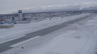 AK0001_1327 - 4K aerial stock footage pan across snowy Merrill Field toward Chugach Mountains, Anchorage, Alaska