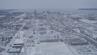 AK0001_1329 - 4K aerial stock footage snow covered Downtown Anchorage near the Cook Inlet, Alaska