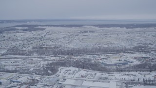 AK0001_1330 - 4K aerial stock footage flying past snow covered Elmendorf Air Force Base, Anchorage, Alaska