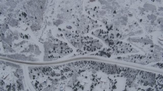 AK0001_1344 - 4K aerial stock footage bird's eye view of homes and snowy mountain slope, Eagle River, Alaska
