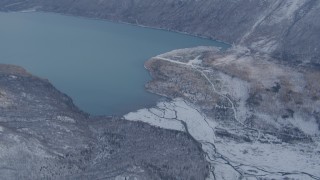 AK0001_1354 - 4K aerial stock footage Eklutna Lake surrounded by snow covered ground, Alaska