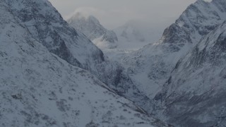 AK0001_1366 - 4K aerial stock footage snow covered Chugach Mountains and low clouds, Alaska