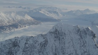 AK0001_1375 - 4K stock footage aerial video flying toward snowy ridge, Knik Glacier, Chugach Mountains, Alaska