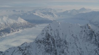 AK0001_1376 - 4K aerial stock footage video flying toward snowy ridge, Knik Glacier, Chugach Mountains, Alaska