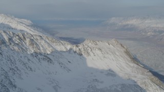 AK0001_1378 - 4K stock footage aerial video a rocky, snow covered mountain ridge, Chugach Mountains, Alaska