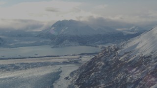 AK0001_1383 - 4K aerial stock footage Inner Lake George between Knik Glacier and Chugach Mountains in snow, Alaska