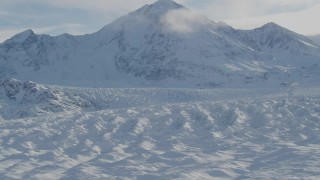 AK0001_1401 - 4K aerial stock footage zoom out revealing snow covered Knik Glacier, Chugach Mountains, Alaska