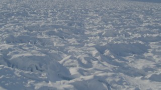 AK0001_1402 - 4K aerial stock footage flying over surface of the snow covered Knik Glacier, Alaska