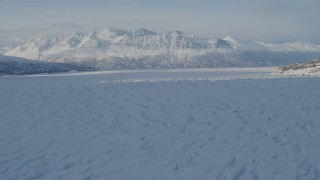 AK0001_1404 - 4K aerial stock footage flying across surface of snow covered Knik Glacier, Alaska