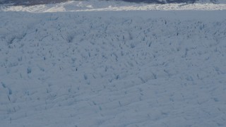 AK0001_1408 - 4K aerial stock footage the shadowed, snow covered surface of the Knik Glacier, Alaska
