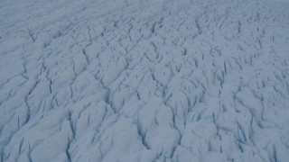 AK0001_1409 - 4K aerial stock footage the cracked, snow covered surface of the Knik Glacier, Alaska