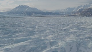 AK0001_1427 - 4K aerial stock footage flying over snow covered surface of Knik Glacier, Alaska