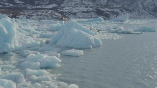 AK0001_1440 - 4K aerial stock footage flying over glacial ice on Inner Lake George, Alaska with snow