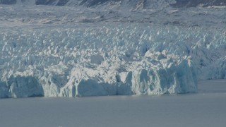 AK0001_1443 - 4K aerial stock footage the edge of a snow covered glacier on Inner Lake George, Alaska