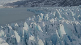 AK0001_1453 - 4K aerial stock footage flying over jagged, snowy surface of glacier on Inner Lake George, Alaska