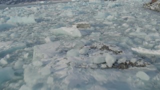 AK0001_1458 - 4K aerial stock footage flying low over pieces of ice on Inner Lake George, Alaska in snow