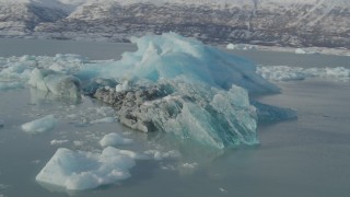 AK0001_1460 - 4K aerial stock footage orbiting glacial ice on Inner Lake George, Alaska in snow