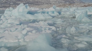 AK0001_1464 - 4K aerial stock footage flying over pieces of ice on Inner Lake George, Alaska in snow
