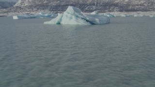 AK0001_1465 - 4K aerial stock footage flying low over surface of Inner Lake George past glacial ice, Alaska in snow
