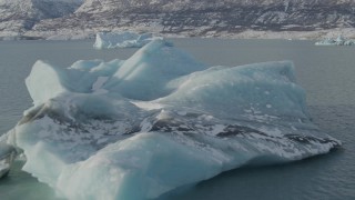 AK0001_1466 - 4K aerial stock footage flying over surface of Inner Lake George toward pieces of glacial ice, Alaska in snow