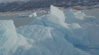 AK0001_1469 - 4K aerial stock footage flying over a piece of glacial ice on Inner Lake George, Alaska in snow