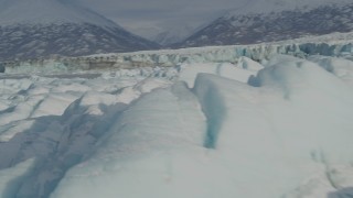 AK0001_1479 - 4K aerial stock footage flying over surface of the snow covered glacier on Inner Lake George, Alaska