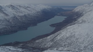 AK0001_1493 - 4K aerial stock footage a snowy mountain ridge, Eklutna Lake, Knik River Valley, Alaska