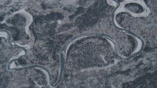 AK0001_1505 - 4K aerial stock footage pan along Eagle River revealing snowy neighborhoods at end of valley, Alaska