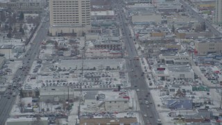 AK0001_1520 - 4K aerial stock footage following East 5th Avenue in snow, Downtown Anchorage, Alaska