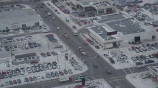 AK0001_1521 - 4K aerial stock footage snow covered auto dealerships on East 5th Avenue, Downtown Anchorage, Alaska