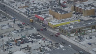 AK0001_1522 - 4K aerial stock footage light traffic on East 5th Avenue in Downtown Anchorage, Alaska in snow