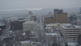 AK0001_1526 - 4K aerial stock footage fly over Cook Inlet, West 4th Avenue, snowy Downtown Anchorage, Alaska