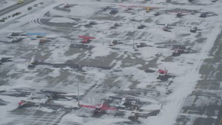 AK0001_1529 - 4K aerial stock footage descend toward parked airplanes at snowy Merrill Field, Anchorage, Alaska