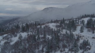 AK0001_1537 - 4K aerial stock footage flying low over homes on snowy foothills, Eagle River, Alaska