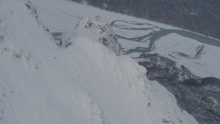 AK0001_1571 - 4K aerial stock footage rounding snowy peak revealing Knik River Valley, Chugach Mountains, Alaska