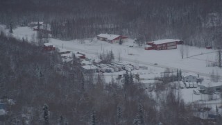 AK0001_1624 - 4K aerial stock footage snow covered shops on Old Glenn Highway, Chugiak, Alaska
