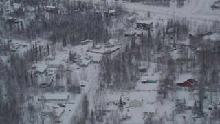 AK0001_1627 - 4K aerial stock footage a snowy neighborhood on Old Glenn Highway, Chugiak, Alaska