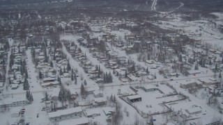 AK0001_1633 - 4K aerial stock footage flying over Eagle River residential neighborhoods, covered in snow, Alaska